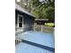 Side view of a blue home with a matching deck and adjacent carport at 225 Meadow Dr, Henderson, NC 27537
