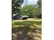 Exterior shot showcasing a gravel driveway, carport and the home's charming facade at 225 Meadow Dr, Henderson, NC 27537