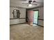 Inviting living room features neutral carpet, classic wall trim, and a light pink door leading to the outdoor porch at 225 Meadow Dr, Henderson, NC 27537