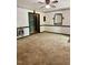 Living room with neutral carpet, classic wall trim, and a classic, wall-mounted heater at 225 Meadow Dr, Henderson, NC 27537