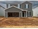 New two-story home with gray siding, open garage and unfinished landscaping at 2250 Cherry Creek Rd, Haw River, NC 27258