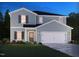 Charming two-story home with blue siding, shutters, green lawn and manicured landscaping at 2250 Cherry Creek Rd, Haw River, NC 27258