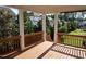 Covered back porch featuring a wooden railing overlooking the back yard at 2309 Redbridge Ln, Apex, NC 27502