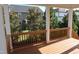 View from the covered porch of the lush backyard landscaping and neighboring homes at 2309 Redbridge Ln, Apex, NC 27502