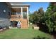 Backyard with a covered patio, a wooden staircase, and well-manicured landscaping at 2309 Redbridge Ln, Apex, NC 27502