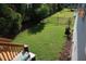 Spacious backyard with lush green grass, a small garden, and a wooden staircase at 2309 Redbridge Ln, Apex, NC 27502