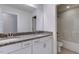 Bright bathroom featuring a double vanity with granite countertops, framed mirror and a tub with shower at 2309 Redbridge Ln, Apex, NC 27502