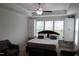 Bright bedroom with a ceiling fan, large window, and ample storage with built-in cabinets at 2309 Redbridge Ln, Apex, NC 27502