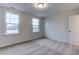 Bedroom featuring neutral colored walls and carpet, and two windows allowing for natural light at 2309 Redbridge Ln, Apex, NC 27502