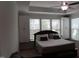 Well-lit bedroom features a ceiling fan, large window, and ample storage with built-in cabinets at 2309 Redbridge Ln, Apex, NC 27502