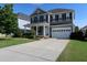 Charming two-story home with a manicured lawn, two car garage, and a welcoming light blue front door at 2309 Redbridge Ln, Apex, NC 27502