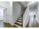 Inviting hallway with beautiful hardwood floors and a staircase leading to the upper level at 2309 Redbridge Ln, Apex, NC 27502