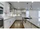 Modern kitchen with stainless steel appliances, granite countertops, white cabinets, and a large island sink at 2309 Redbridge Ln, Apex, NC 27502