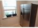 Stainless steel refrigerator next to a window with plants at 2309 Redbridge Ln, Apex, NC 27502