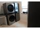 Laundry room with modern washer and dryer setup and utility sink at 2309 Redbridge Ln, Apex, NC 27502