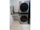 Laundry room featuring a modern, stacked washer and dryer unit at 2309 Redbridge Ln, Apex, NC 27502