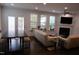 Bright living room with large windows, a fireplace, and comfortable seating, creating a cozy atmosphere at 2309 Redbridge Ln, Apex, NC 27502