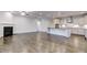 Bright living room featuring hardwood floors, a fireplace, and an open concept to the modern kitchen at 2309 Redbridge Ln, Apex, NC 27502