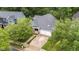 Aerial view of a charming home with mature trees, driveway and a two-car garage at 2313 Filigree Ct, Raleigh, NC 27614