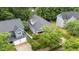 Aerial view of a charming home with a fenced backyard, mature trees, and driveway at 2313 Filigree Ct, Raleigh, NC 27614