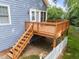 View of back deck showing stairs, railings, and door access to home with rock undercarriage at 2313 Filigree Ct, Raleigh, NC 27614