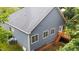 Aerial view of backyard showing back deck, white trim, blue siding, and mature trees at 2313 Filigree Ct, Raleigh, NC 27614
