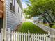 View of house with backyard showing mature tree line and white picket fence at 2313 Filigree Ct, Raleigh, NC 27614