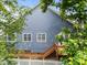 Back exterior shot showing stairs to deck, white picket fence, and several windows at 2313 Filigree Ct, Raleigh, NC 27614