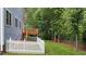 Exterior rear view of home featuring backyard with deck and mature trees at 2313 Filigree Ct, Raleigh, NC 27614