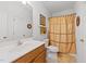 Well-lit bathroom features a shower with a curtain, neutral colors, and a vanity at 2313 Filigree Ct, Raleigh, NC 27614