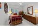 Comfortable bedroom features a large window, wooden furniture, and a ceiling fan at 2313 Filigree Ct, Raleigh, NC 27614