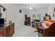 Bedroom featuring large window, ceiling fan, wood desk and cabinet, and neutral colors at 2313 Filigree Ct, Raleigh, NC 27614
