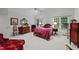 Bright bedroom featuring two windows, a vaulted ceiling, hardwood furniture and an elegant red chair at 2313 Filigree Ct, Raleigh, NC 27614