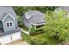 Charming blue house with gray roof, inviting porch, manicured lawn, and white picket fence at 2313 Filigree Ct, Raleigh, NC 27614
