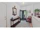 Inviting foyer with elegant table, decorative mirror, chair, and view of the front porch at 2313 Filigree Ct, Raleigh, NC 27614