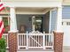 Inviting front porch with rocking chairs and black trimmed windows at 2313 Filigree Ct, Raleigh, NC 27614