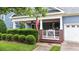 Close-up showcasing brick porch, white railings, seating area, and blue siding of the home at 2313 Filigree Ct, Raleigh, NC 27614