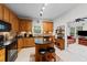 Charming kitchen features wood cabinets, tile backsplash, granite countertops, and kitchen island at 2313 Filigree Ct, Raleigh, NC 27614