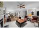 Open-concept living room with fireplace, plush seating, and dining area in the background at 2313 Filigree Ct, Raleigh, NC 27614