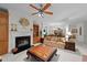 Spacious living room featuring a fireplace, built-in bookshelves, and adjacent dining area at 2313 Filigree Ct, Raleigh, NC 27614