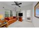 Relaxing living room featuring large windows, a ceiling fan, comfortable seating, and lots of natural light at 2313 Filigree Ct, Raleigh, NC 27614