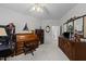 Bright office area with a ceiling fan, beautiful wood desk and bookshelves, and large dresser with mirror at 2313 Filigree Ct, Raleigh, NC 27614