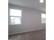 Bedroom with two windows offering natural light and neutral walls over carpet flooring at 2733 Hunter Woods Dr # 570, Apex, NC 27502