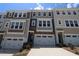 Attractive townhome exteriors display neutral tones and individual attached garages at 2733 Hunter Woods Dr # 570, Apex, NC 27502