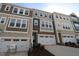 New townhomes with attached garages and neutral exteriors offer modern curb appeal at 2733 Hunter Woods Dr # 570, Apex, NC 27502