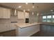Modern kitchen with white cabinets, stainless appliances, island with sink, and open living area at 2733 Hunter Woods Dr # 570, Apex, NC 27502