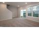 Living room with a sliding glass door for patio access and a large window for natural light at 2733 Hunter Woods Dr # 570, Apex, NC 27502