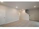Living room features carpet, access to a staircase, and a door leading to another room at 2733 Hunter Woods Dr # 570, Apex, NC 27502