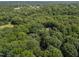 Aerial shot of home nestled within a dense canopy of trees in a secluded, forested neighborhood at 2840 Mattlyn Ct, Raleigh, NC 27613