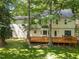 Charming home featuring a backyard deck surrounded by lush greenery and mature trees at 2840 Mattlyn Ct, Raleigh, NC 27613